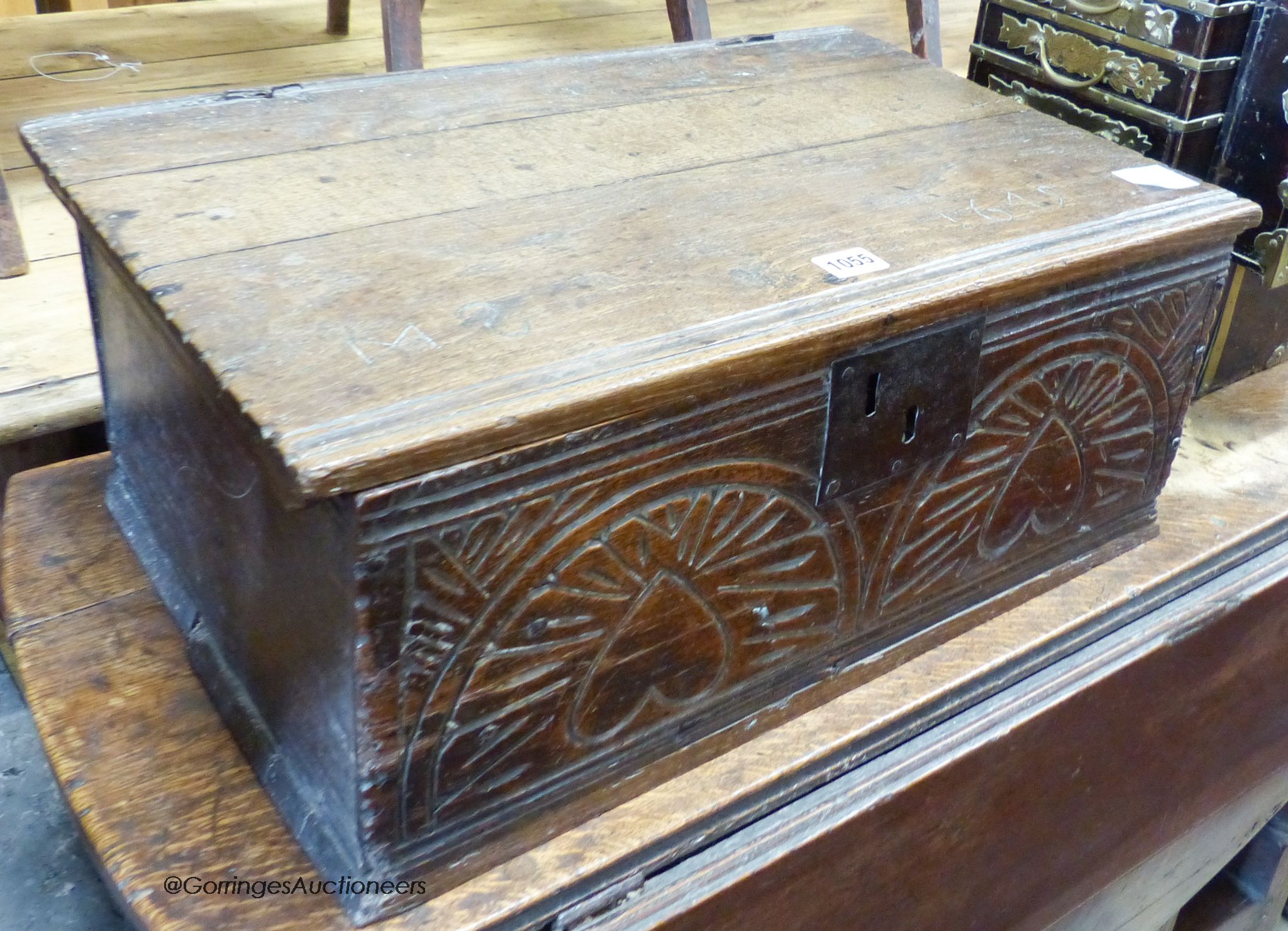 A 17th century carved oak bible box with bible, width 56cm, depth 36cm, height 22cm